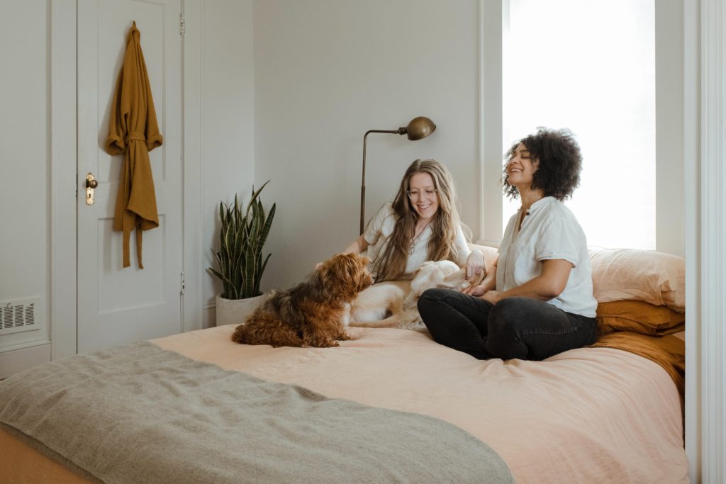 Corinne email Celebrating childfree women | 2 women and a dog chatting on a bed
