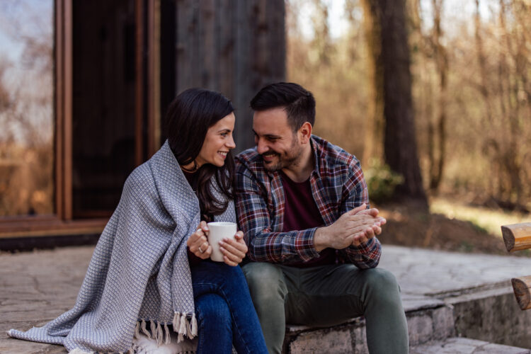 Couple sitting next to each other, deep in conversation, enjoying themselves