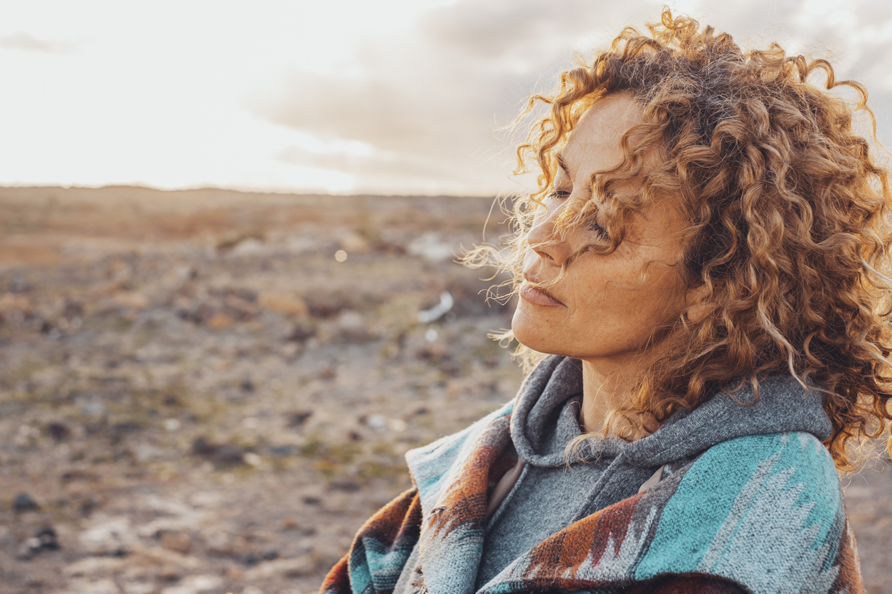 Side View Of Woman Looking Away Woman reconnecting with her body in nature — soft, radiant, peaceful