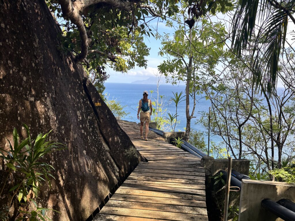 Woman walking alone along a coastal path, symbolizing the inner work of leading in a relationship
